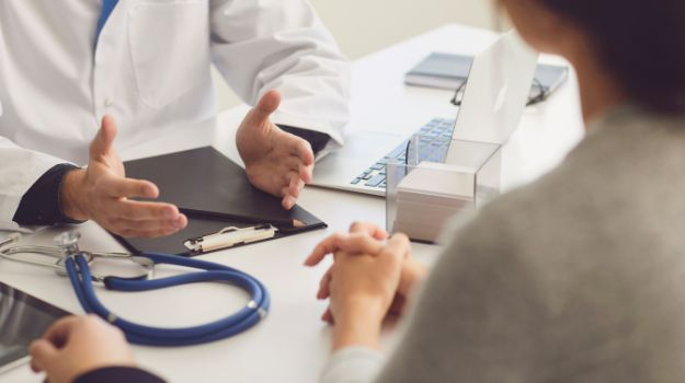 close up of doctor speaking with a patient